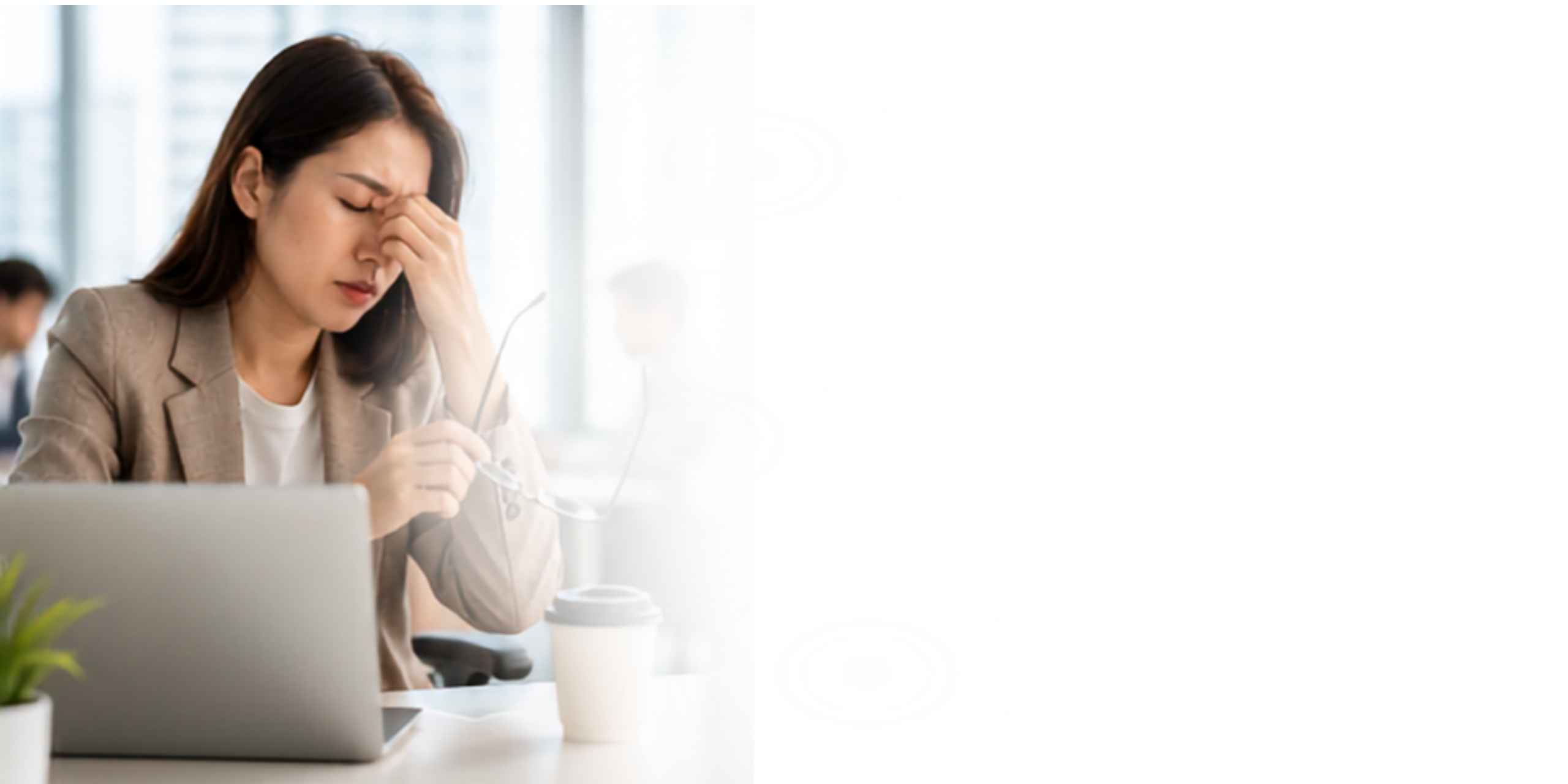 Woman feeling tired and fatigued at her work desk
